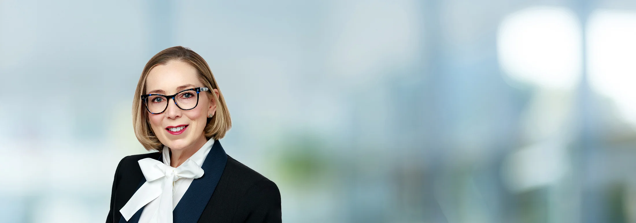 A photo of attorney Jade Butman against a softly blurred office background