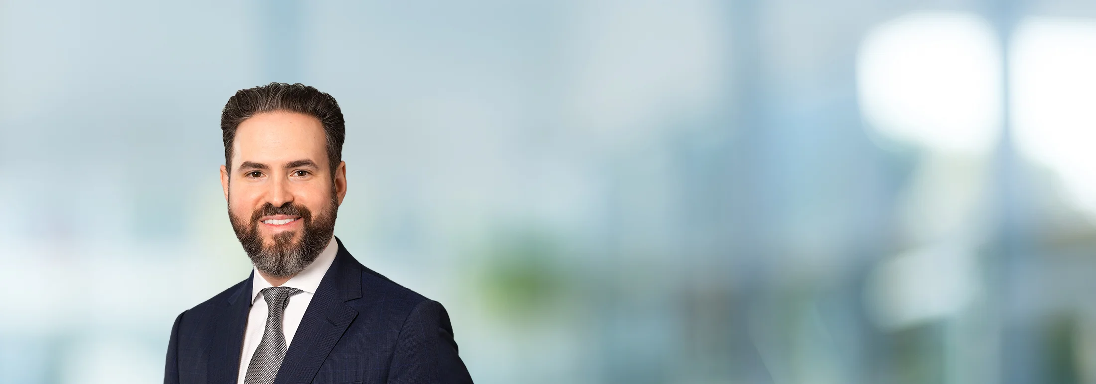A photo of attorney Krikor Moloyan against a softly blurred office background