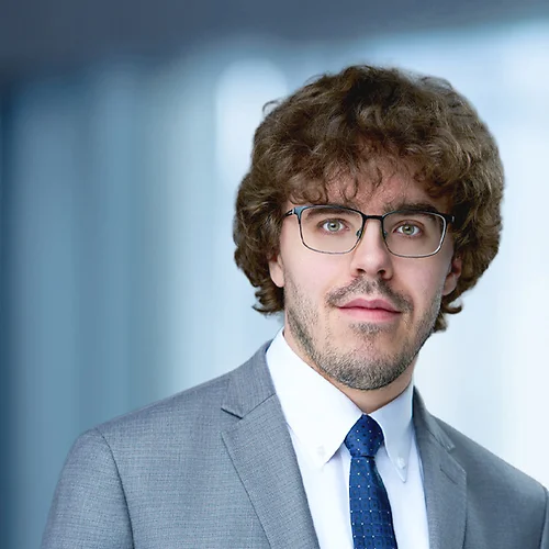 A photo of attorney Dale Wolf against a softly blurred office background