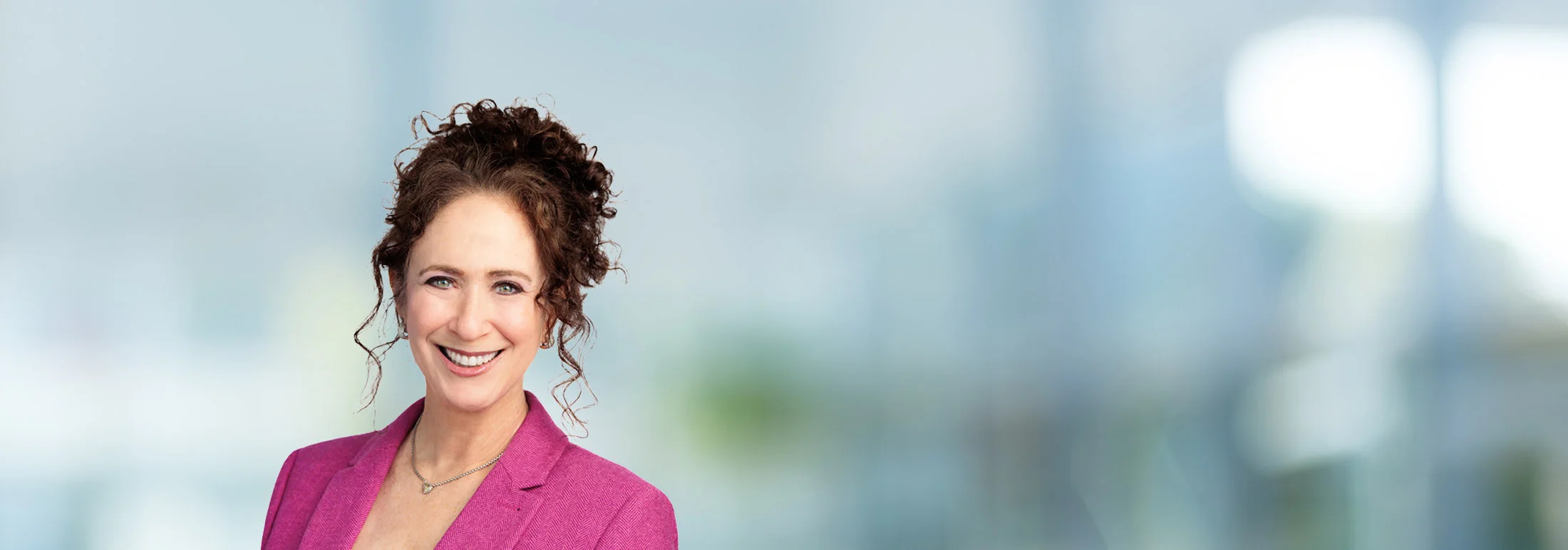 A photo of attorney Joelle Sharman against a softly blurred office background