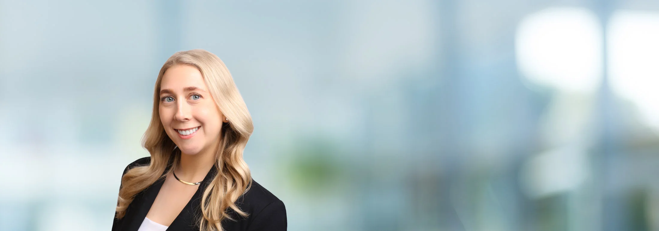 A photo of attorney Anna Ludwick against a softly blurred office background