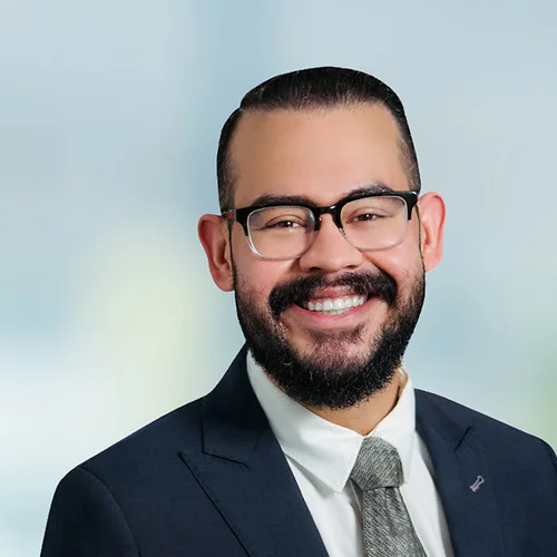 A photo of attorney Daniel Trujillo against a softly blurred office background