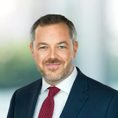 A photo of attorney, Chris Helsel, against a softly blurred office background.