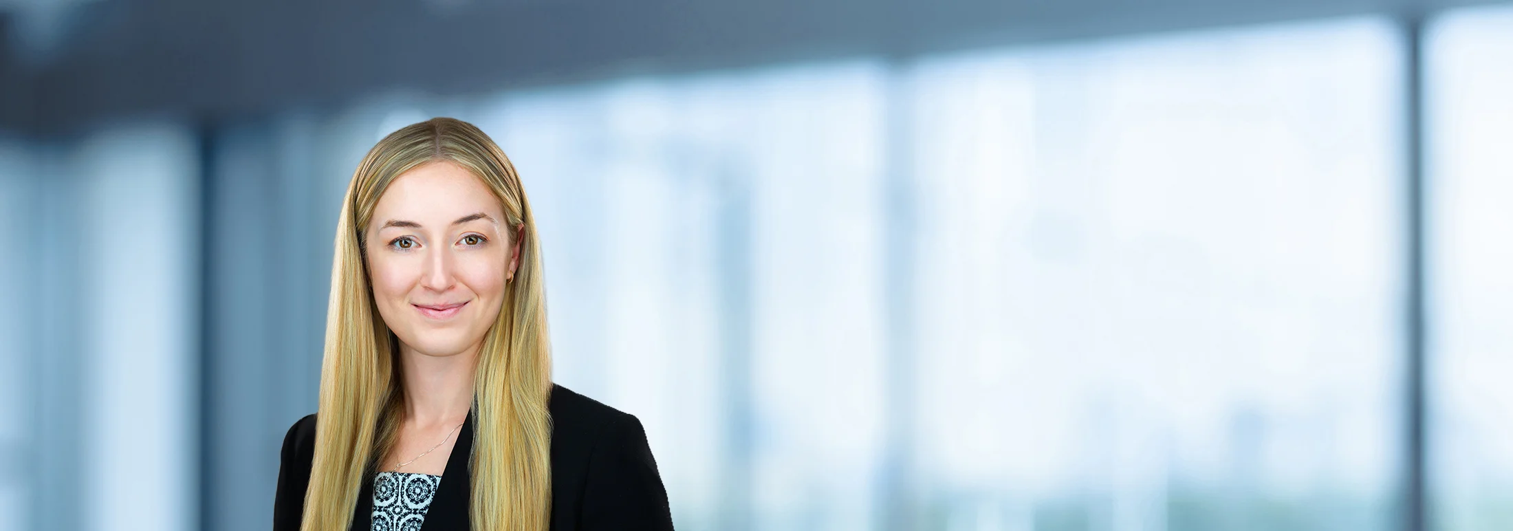 A photo of attorney, Emily Hurley, against a softly blurred office background.
