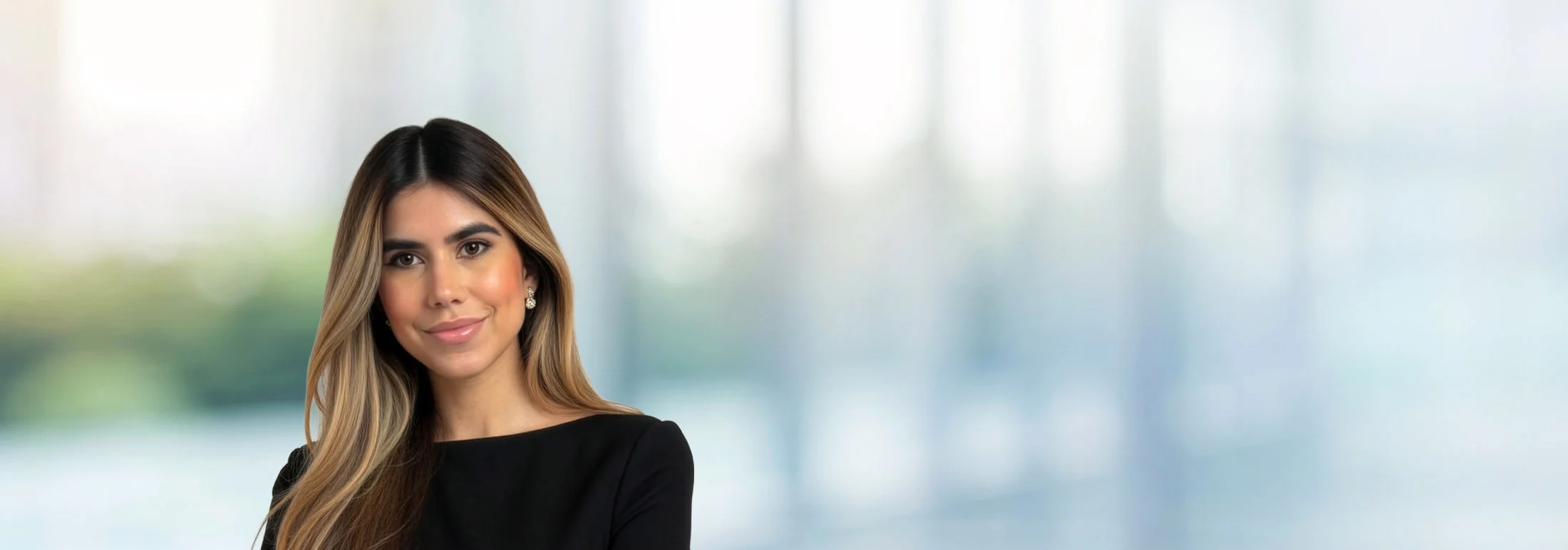 A photo of attorney Nicole Burgos Romero against a softly blurred office background