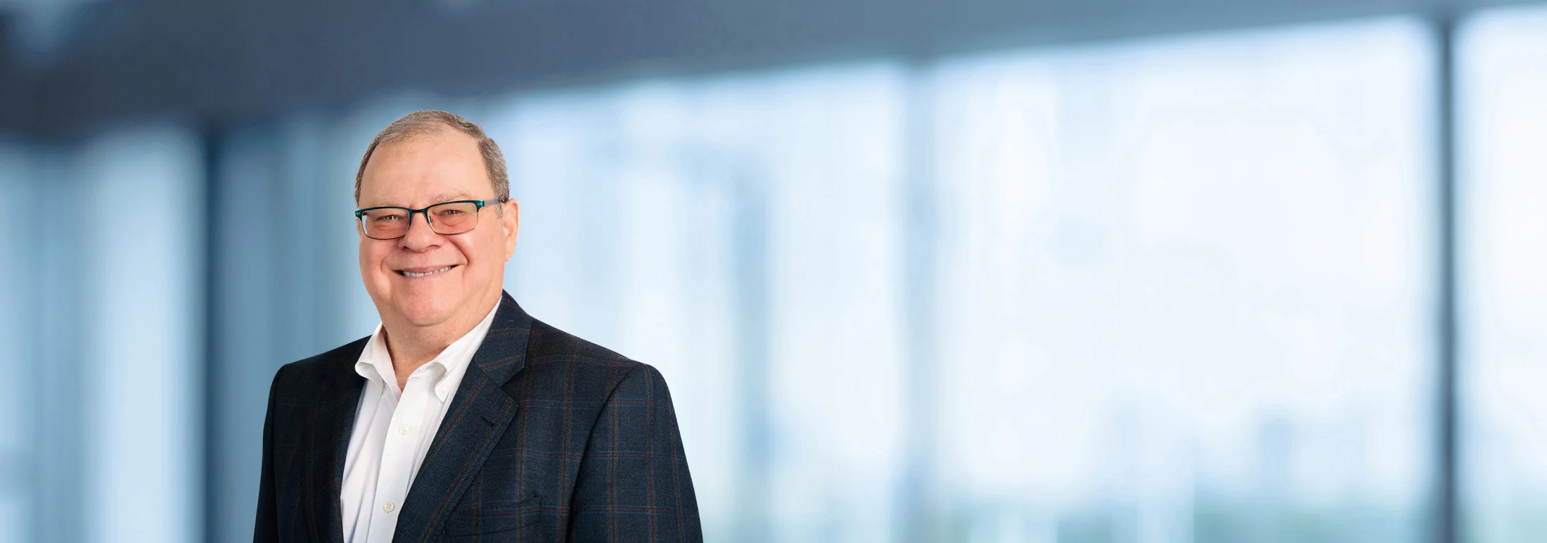 A photo of attorney, Gary Freed, against a softly blurred office background