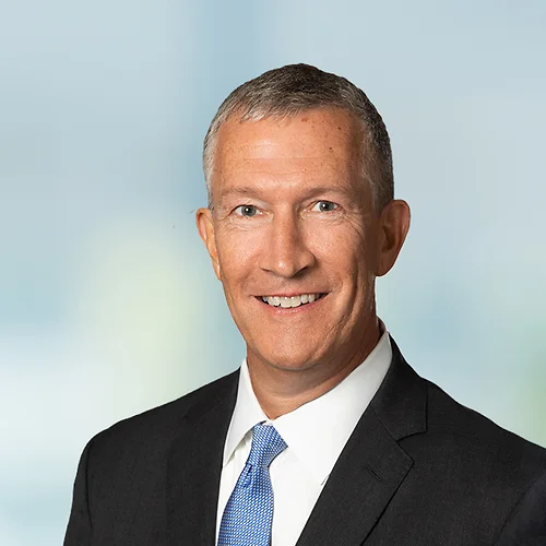 A photo of attorney, Dana Finberg, against a softly blurred office background