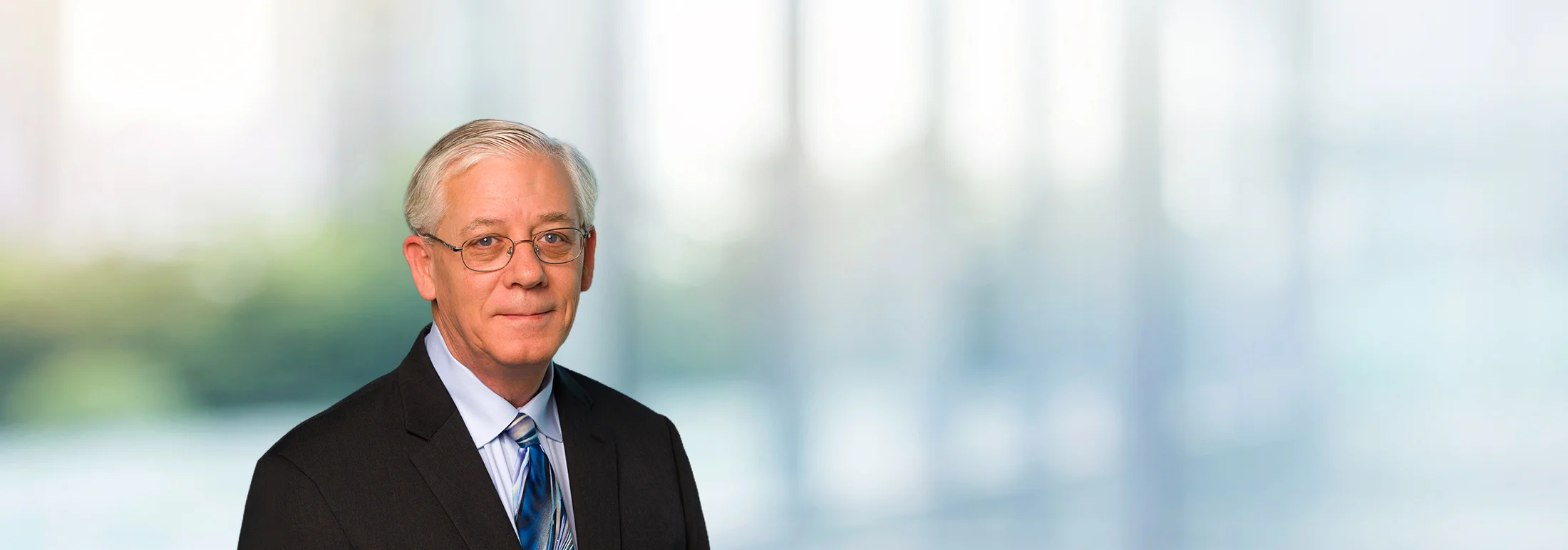 A photo of attorney, Jim Walker, against a softly blurred office background