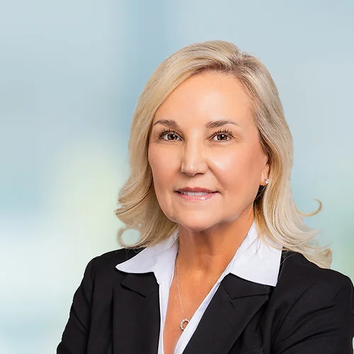 A photo of attorney, Hannah Symonds, against a softly blurred office background.