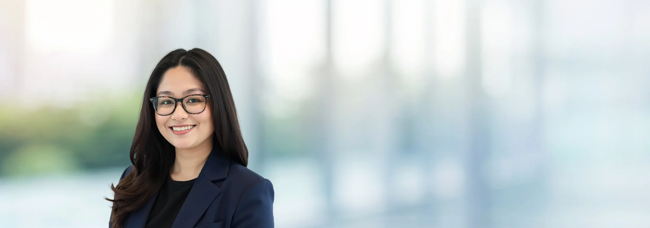 A photo of attorney Iya Merilles against a softly blurred office background