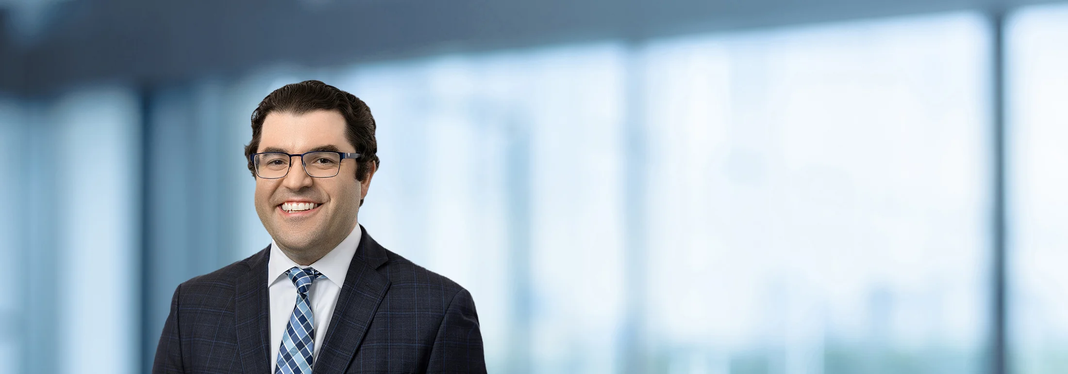 A photo of attorney, Brian Martinez, against a softly blurred office background.