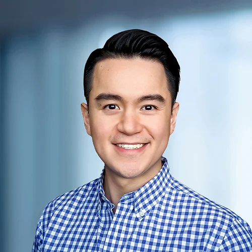 A photo of attorney, Thien Tran, against a softly blurred office background
