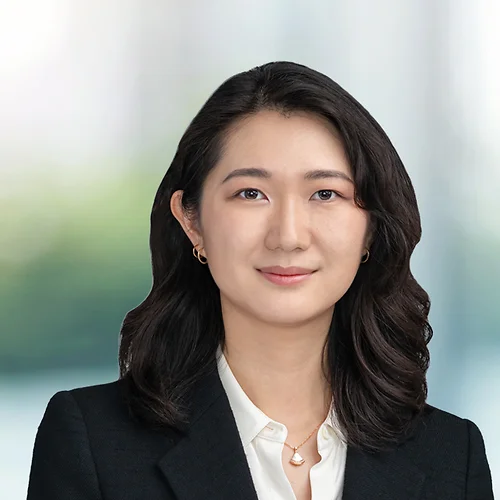 A photo of attorney Millicent Wong against a softly blurred office background