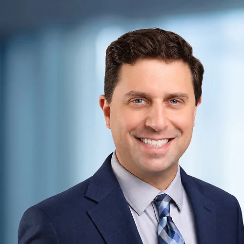 A photo of attorney Adam Yanoff against a softly blurred office background