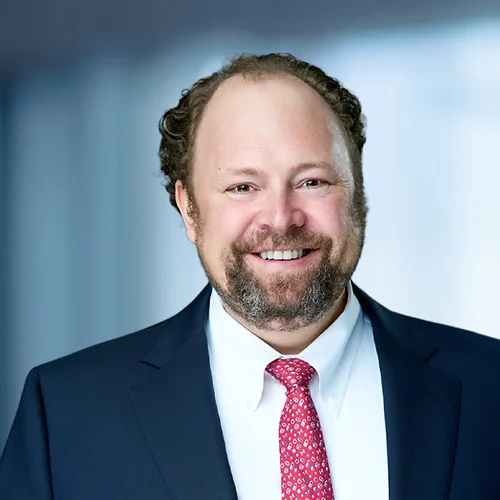 A photo of attorney, Brandon Sieg, against a softly blurred office background