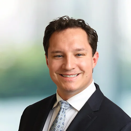 A photo of attorney Ruslan Murphy against a softly blurred office background