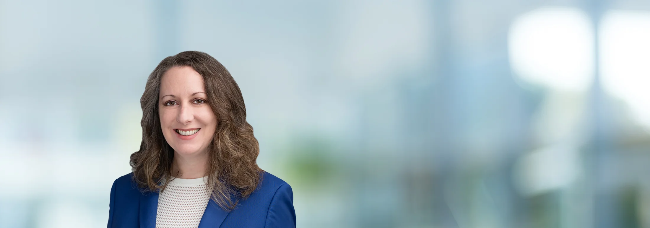 A photo of attorney Alyson Decker against a softly blurred office background