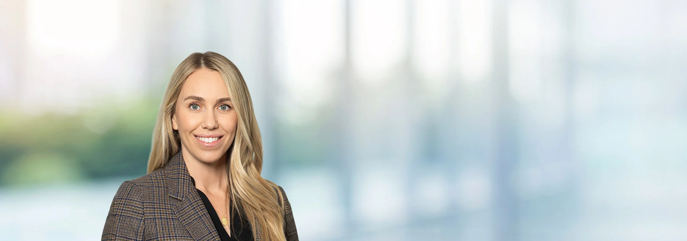 A photo of attorney Natasha Covarrubias against a softly blurred office background