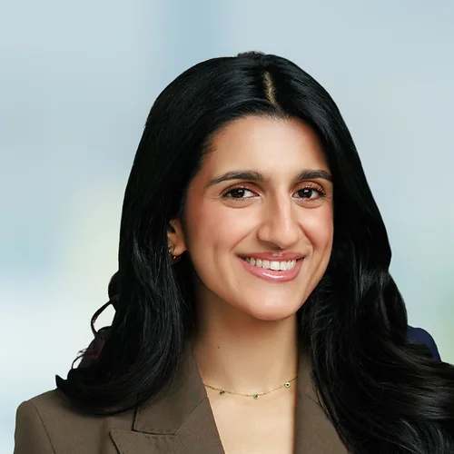A photo of attorney, Zahrah Khan, against a softly blurred office background.