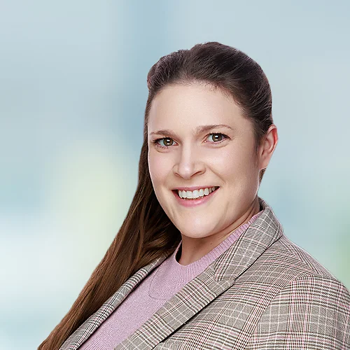 A photo of attorney, Madeleine King, against a softly blurred office background.