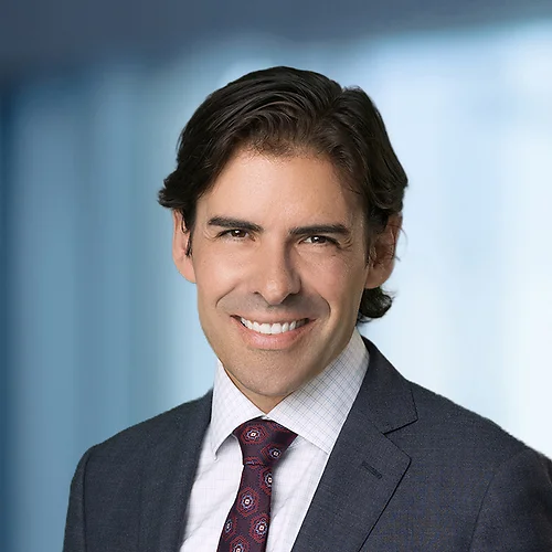 A photo of attorney, Kevin Rasp, against a softly blurred office background.