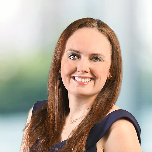 A photo of attorney, Amanda Walsh, against a softly blurred office background.