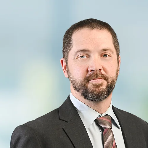 A photo of attorney, Bryan White, against a softly blurred office background.