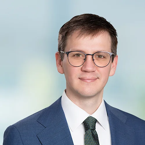 A photo of attorney, Garrett Respondek, against a softly blurred office background.
