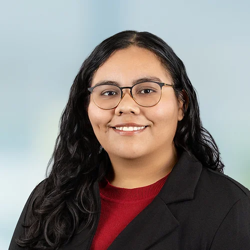 A photo of attorney, Veronica Valdez, against a softly blurred office background