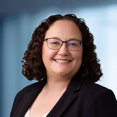 A photo of attorney Melissa LeBlanc-Mansell against a softly blurred office background