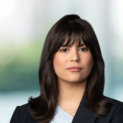 A photo of attorney Juliana Guillen against a softly blurred office background