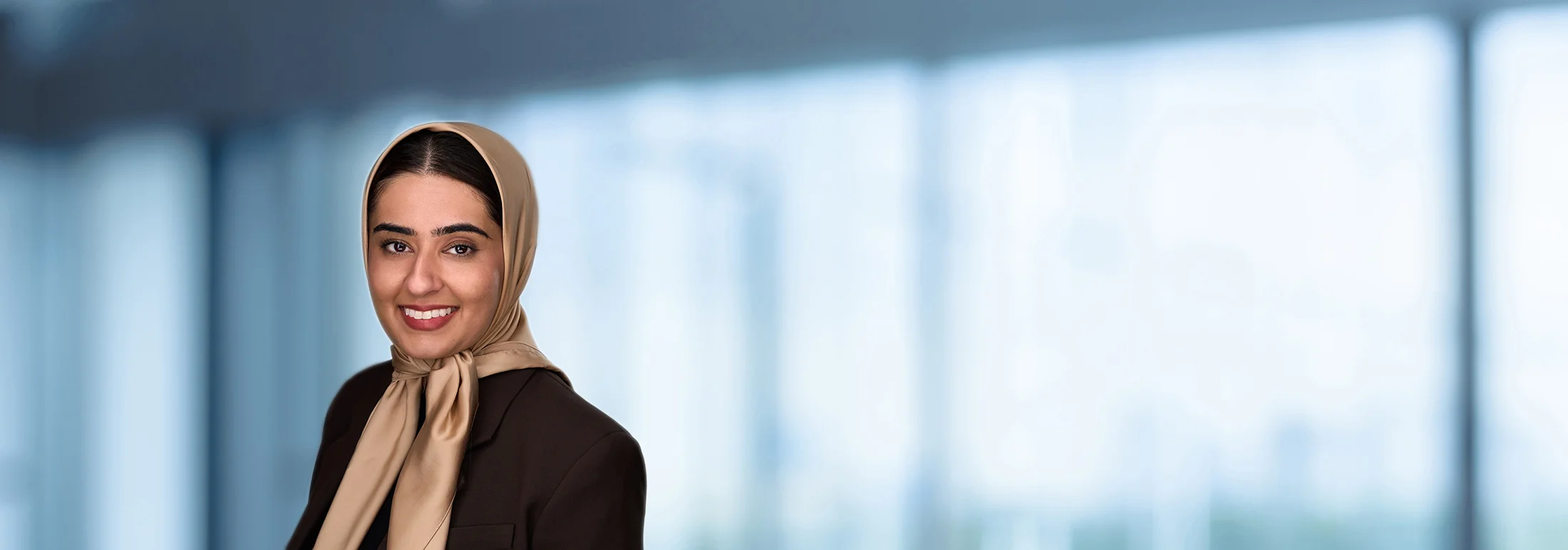 A photo of attorney Tazeen Hussain against a softly blurred office background