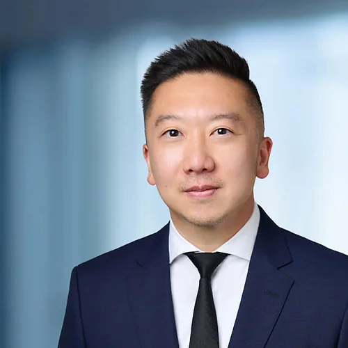 A photo of attorney Brian Lee against a softly blurred office background