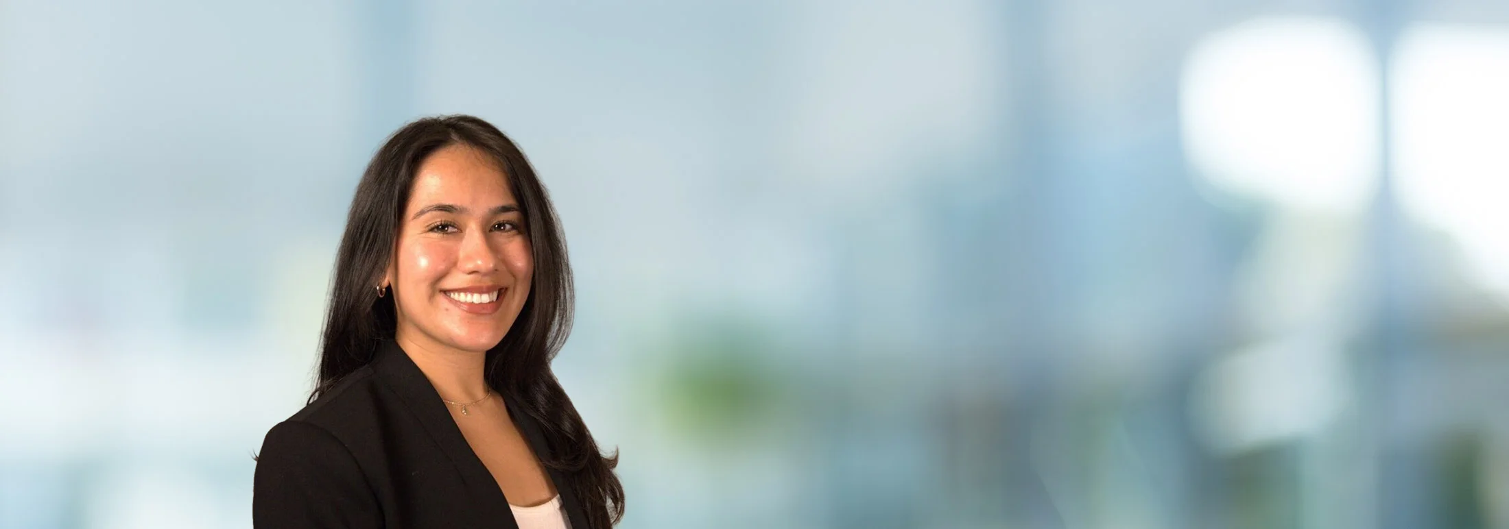 A photo of attorney Bianca Montes against a softly blurred office background