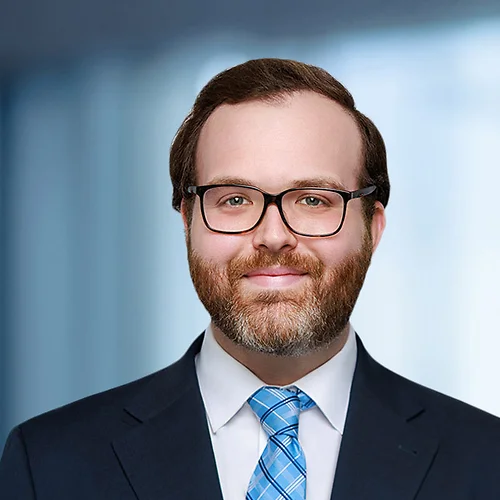 A photo of attorney Thomas Bishop against a softly blurred office background